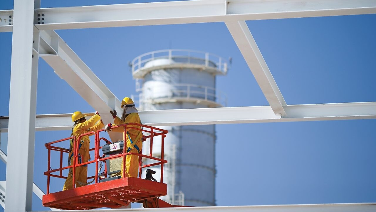 Two engineers on crane doing maintenance work
